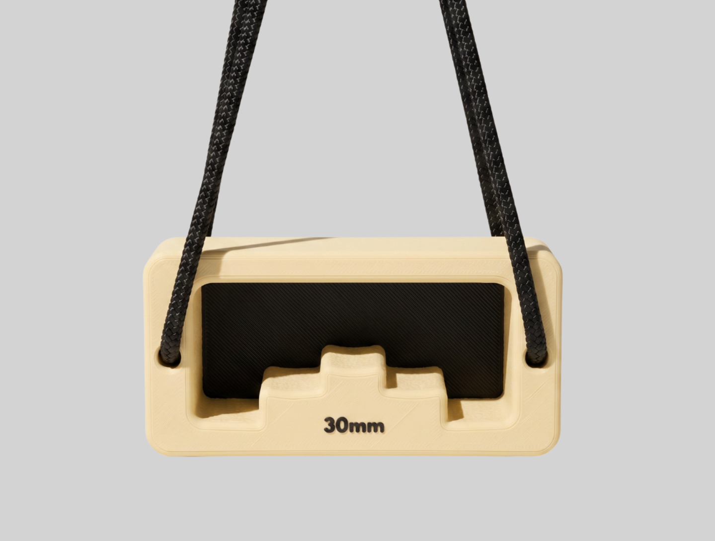 Soft Lemon and Charcoal Dab Block 02 hanging from black cord against a gray background